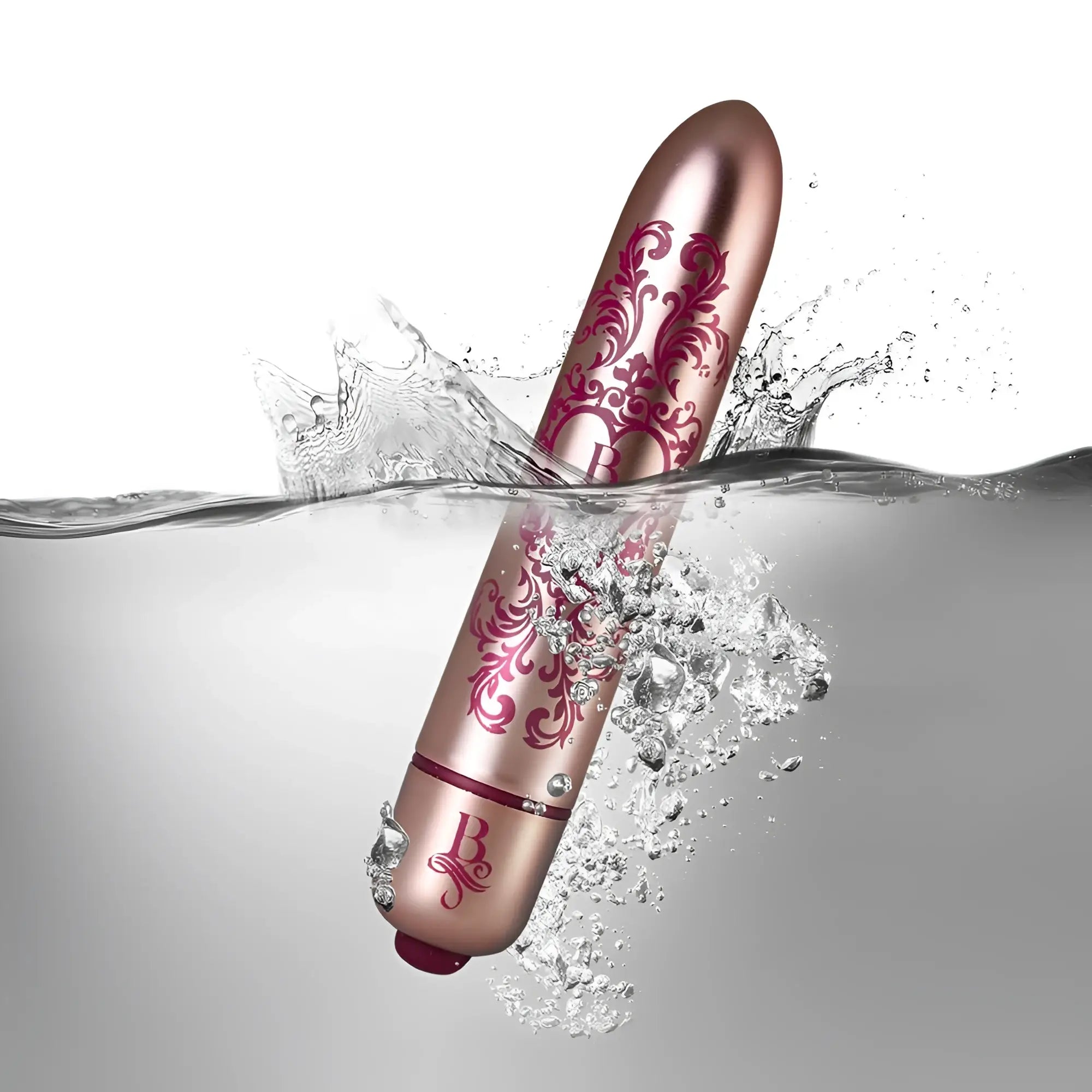 Rose gold cylindrical vibrator with pink floral patterns and branded b logo partially submerged in water rocks off boudoir promenade bullet