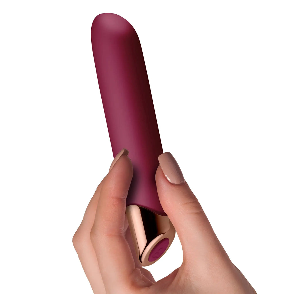 A sleek matte burgundy silicone rechargeable vibrator with rose gold accent and purple button rocks off chaiamo