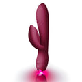 A sleek matte burgundy silicone rabbit vibrator by rocks off with a glowing pink led light at its base