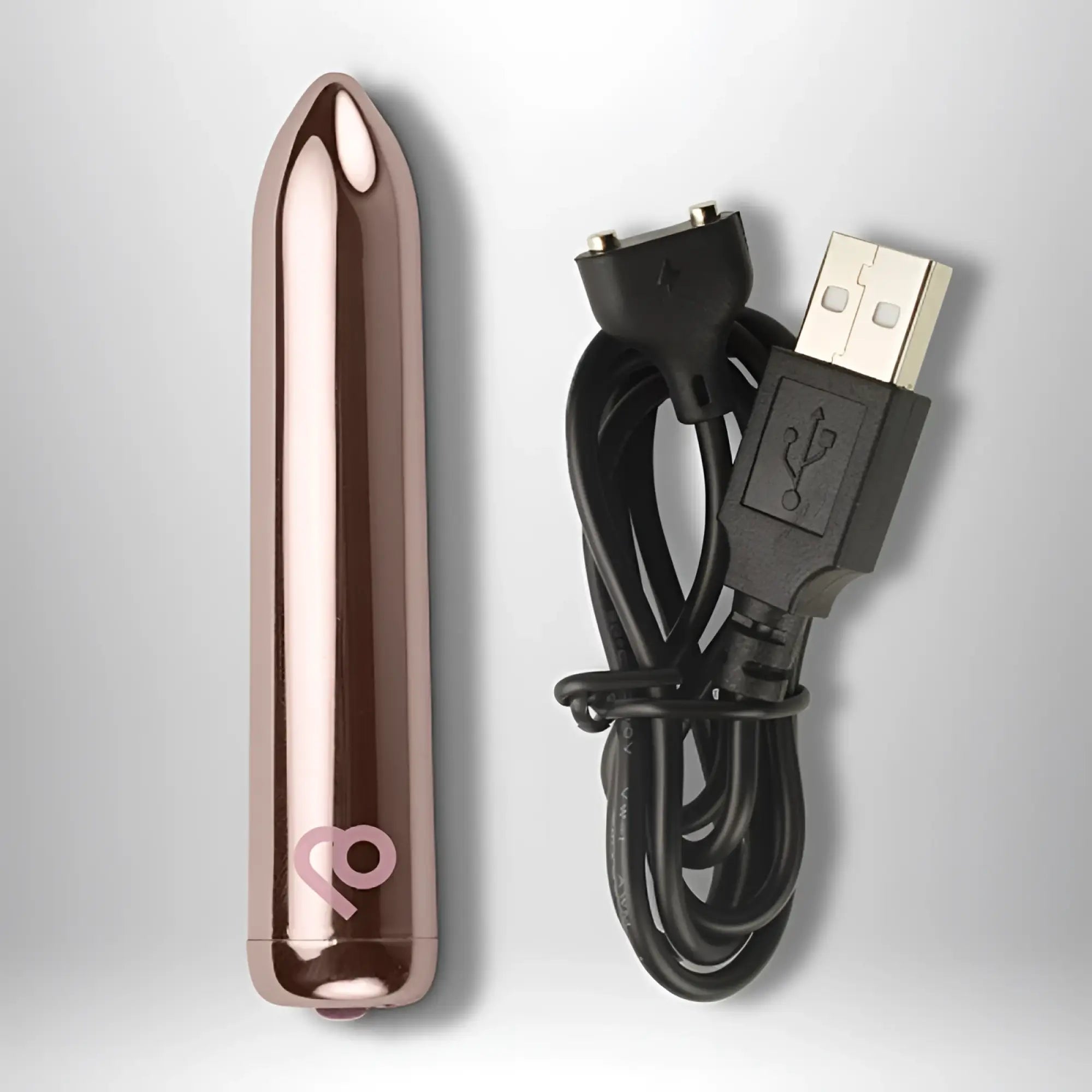 Rose gold metallic cylindrical rechargeable bullet vibrator with subtle pink logo near base by rocks off golden rose