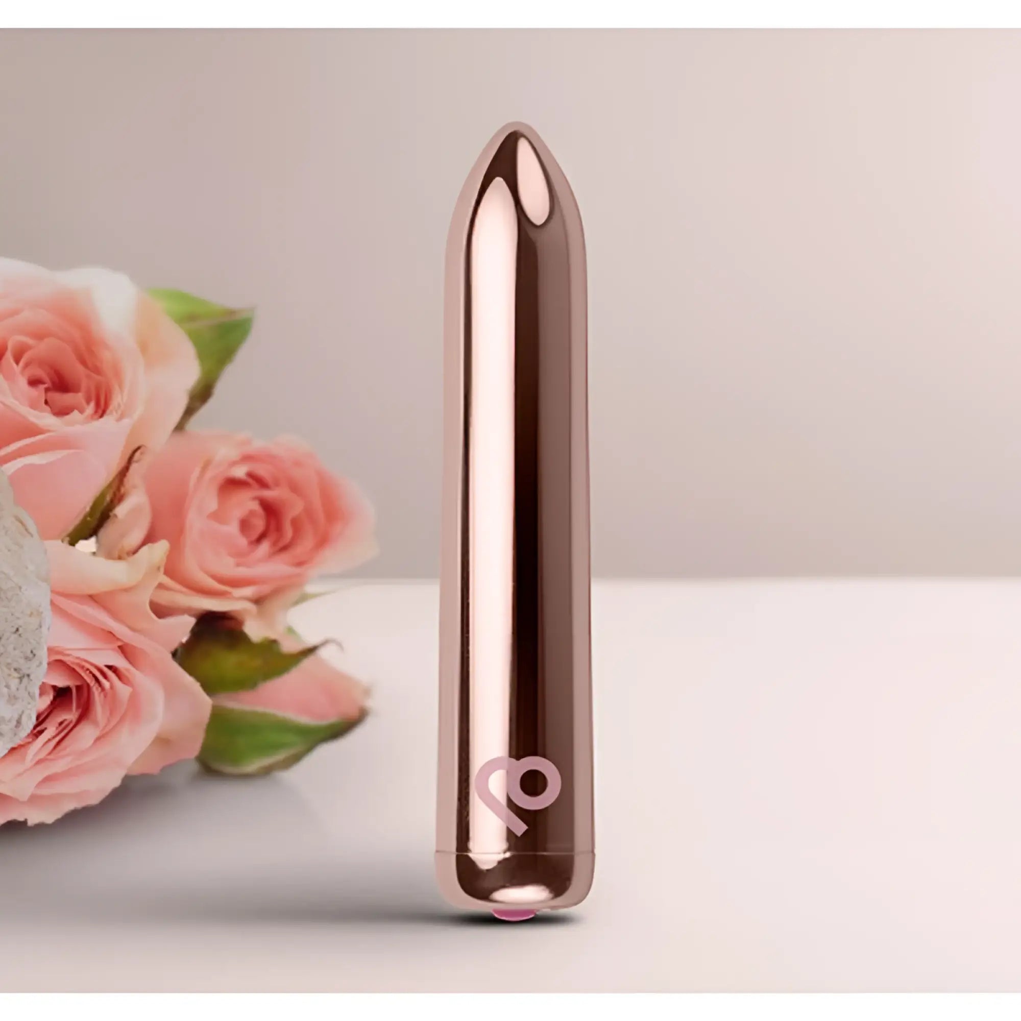 Rose gold metallic cylindrical vibrator with sleek tapered design and subtle logo near base in Rocks Off Golden Rose Rechargeable Bullet