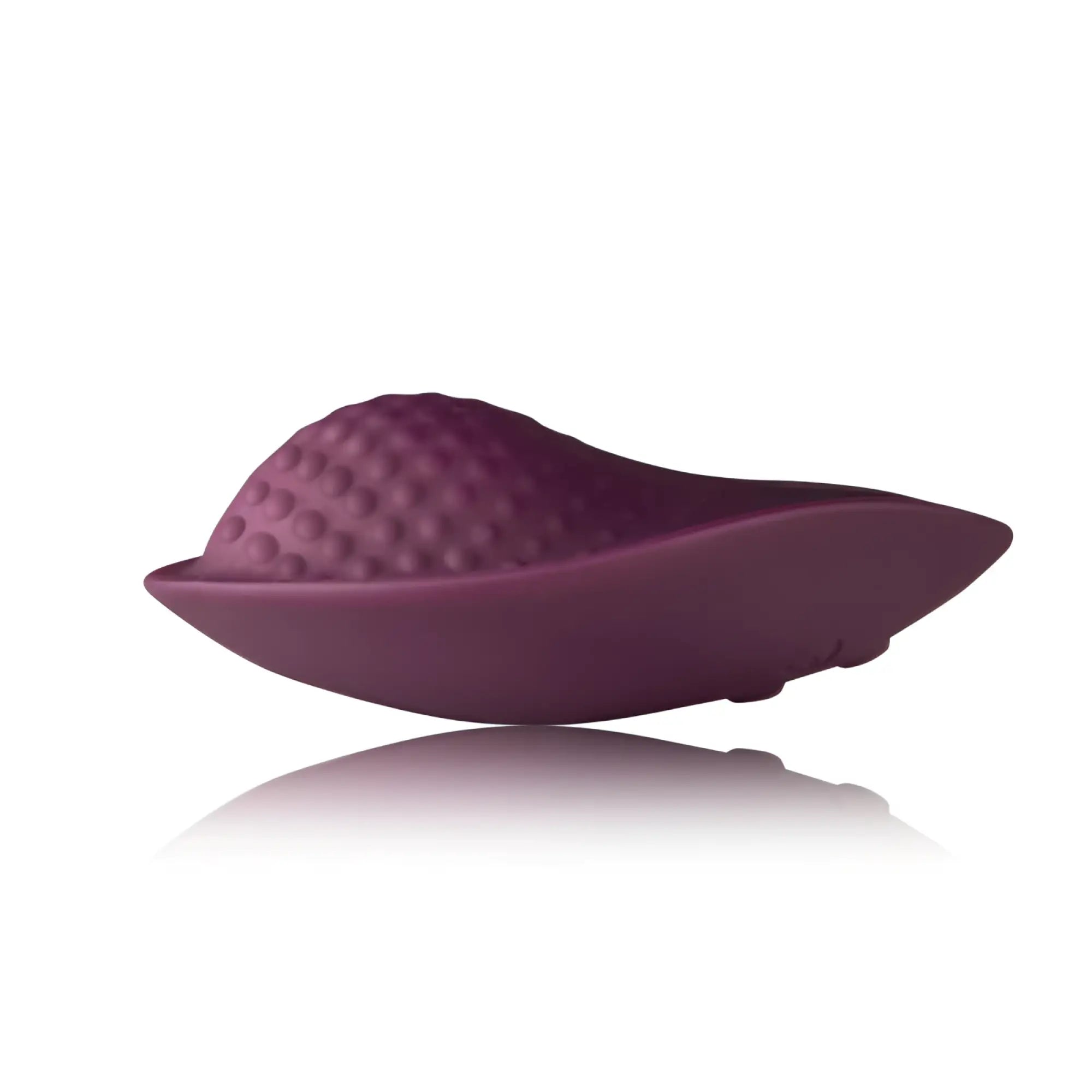 Purple silicone vaginal vibratory device with textured dome top and smooth curved base rocks off knickerbocker glory panty vibe