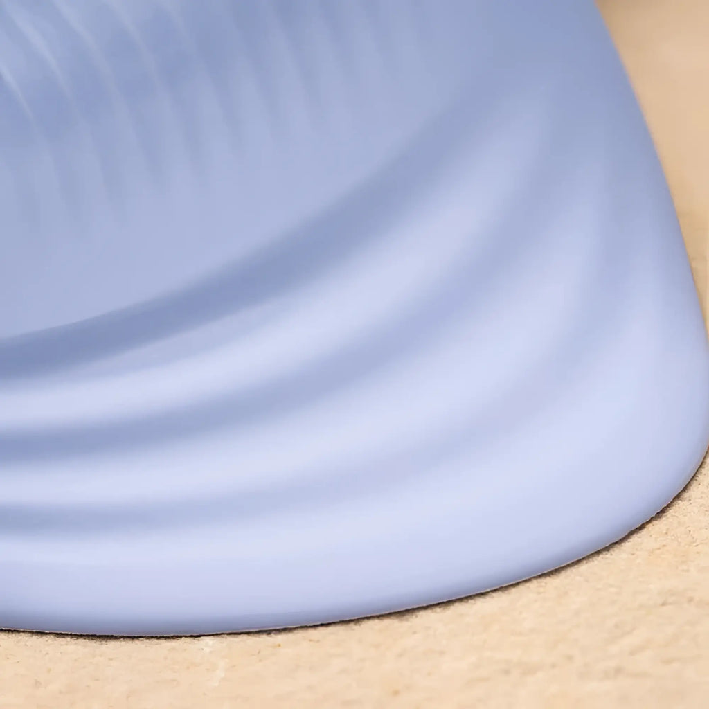 Rocks off niya 5 silicone rechargeable massager with a soft light blue silicone mat featuring curved edge and ribbed texture