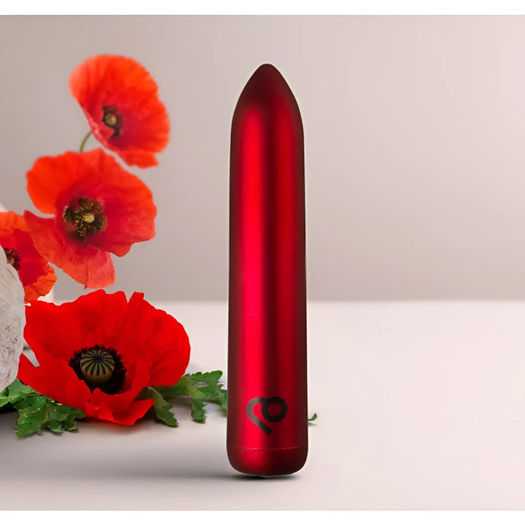 A sleek matte red rechargeable bullet vibrator with a subtle logo near the base by rocks off poppy red