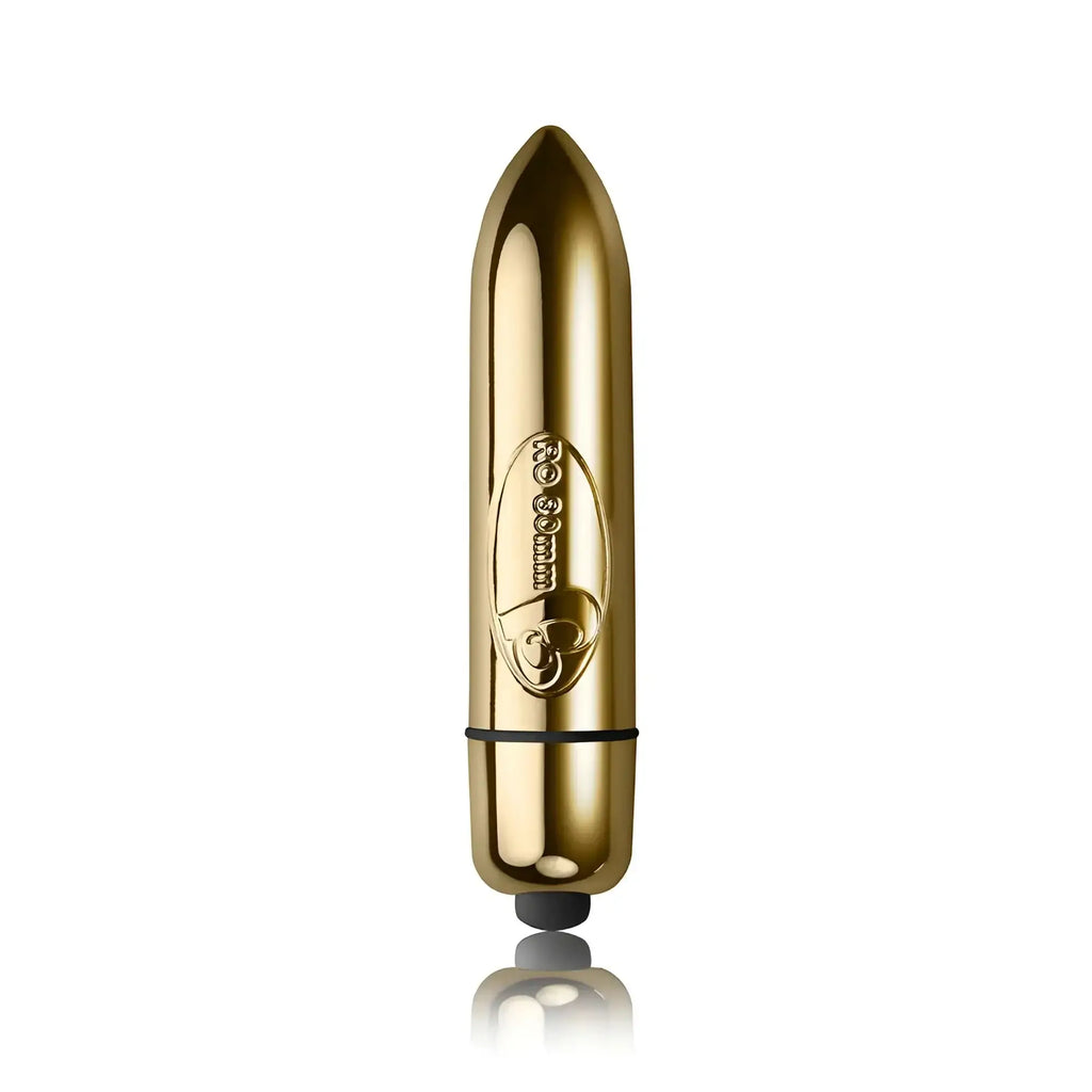 Gold-colored sleek metallic rocks off ro-80 single speed bullet with black rubber tip and engraved oval logo near base
