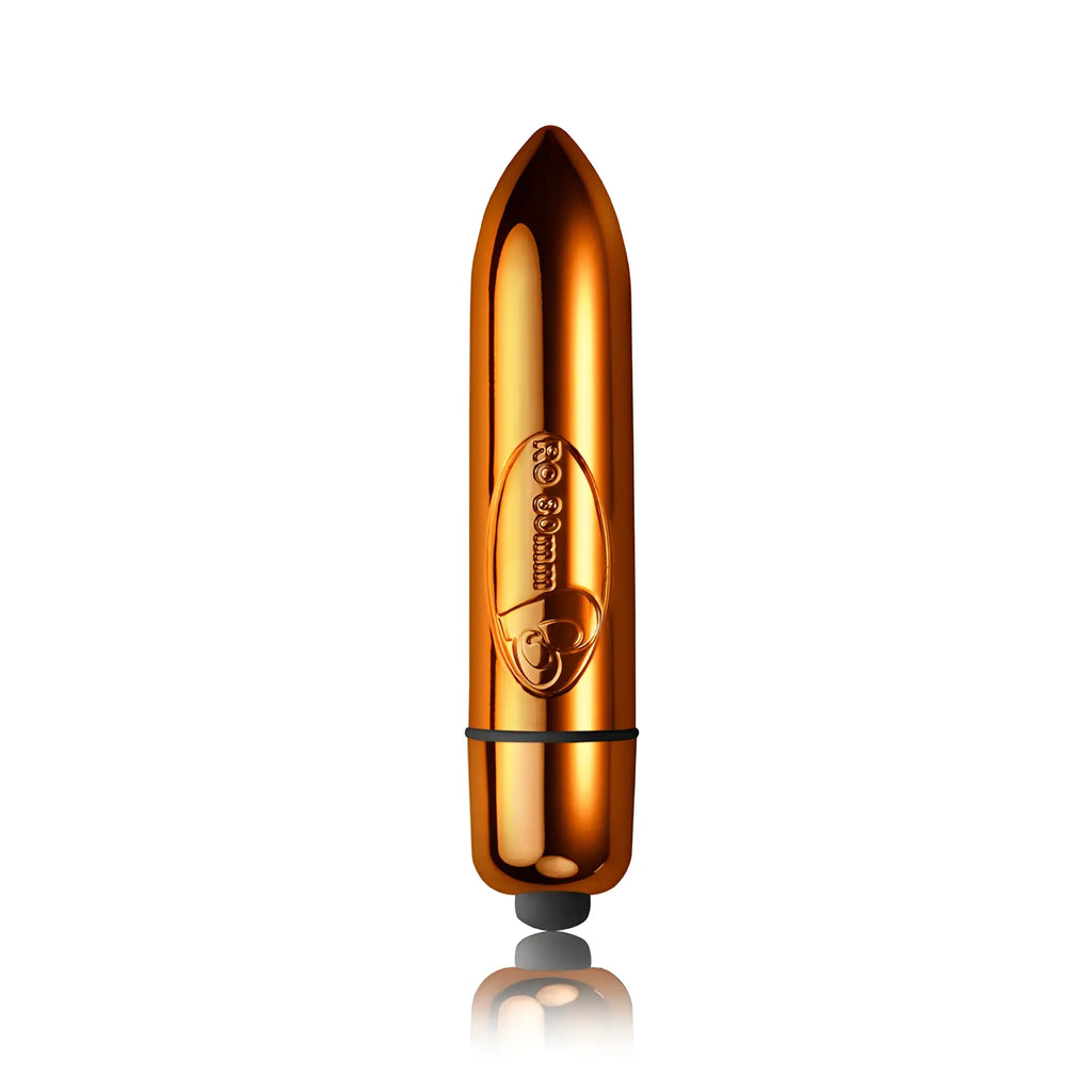 Shiny gold-colored bullet-shaped rocks off ro-80 single speed copper electronic toy with black rubber tip and engraved logo