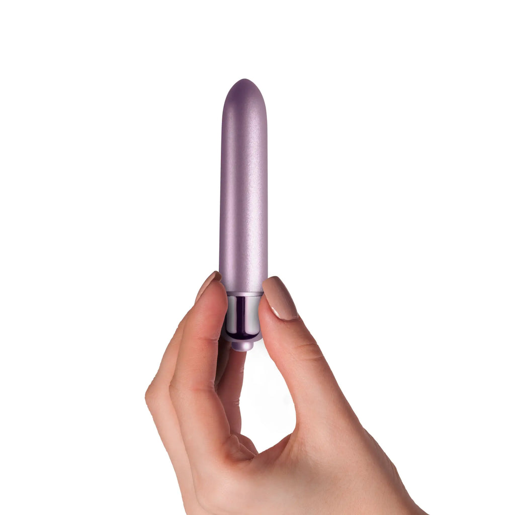 A sleek lavender silicone vibrator with a smooth rounded tip and metallic silver base rocks off RO 90 touch of velvet