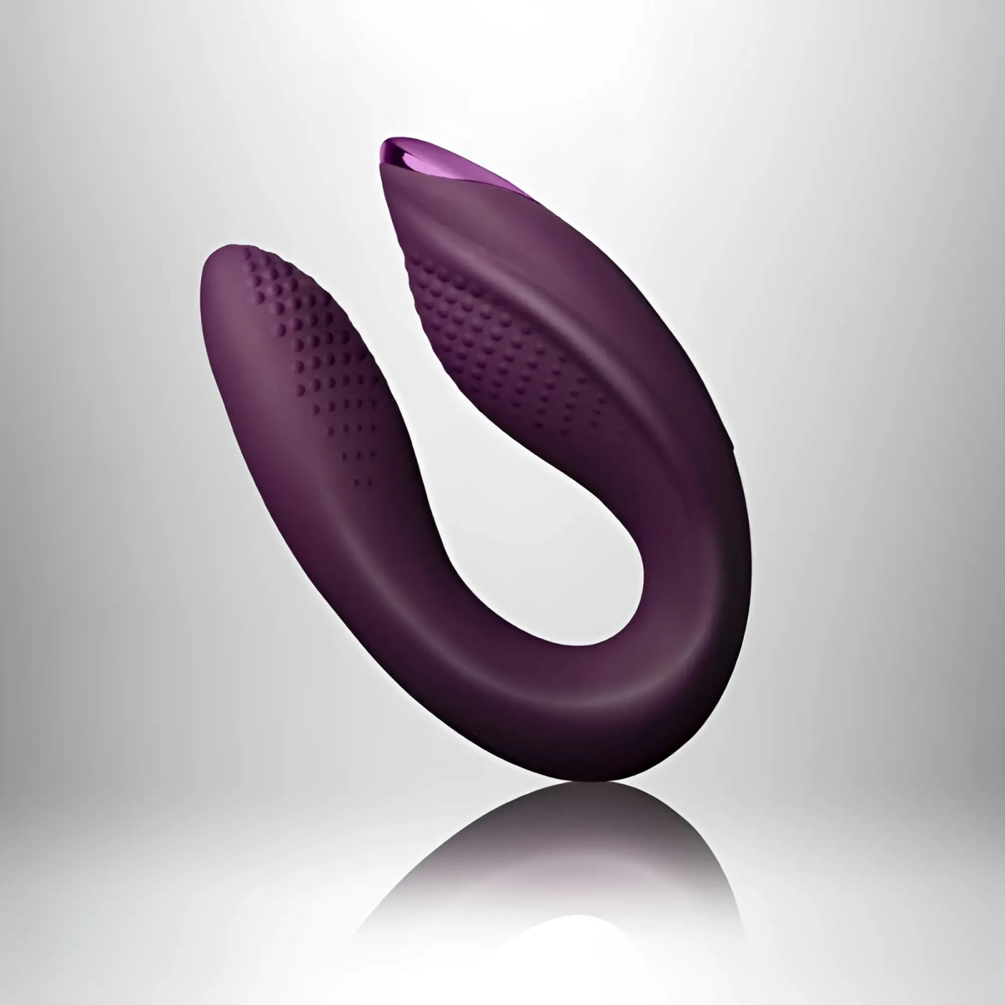 Purple silicone u-shaped vibrator rocks off rock chick diva with textured grip surfaces and smooth curved design
