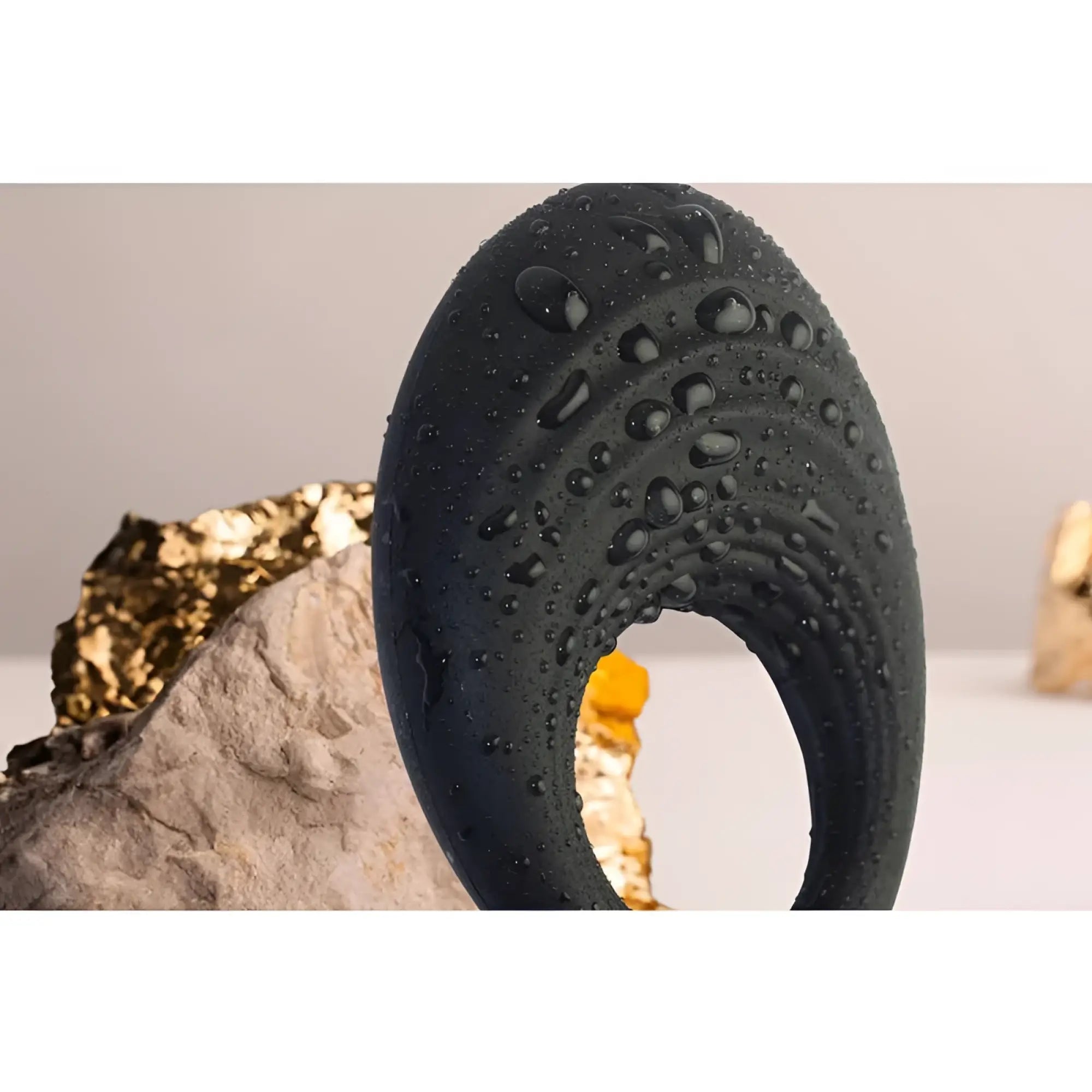 Black matte-finished silicone rocks off spire 10 speed vibrating cock ring with smooth curved design and water droplets
