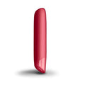 A sleek glossy red cylindrical rocks off sugarboo cool coral bullet vibe with a smooth rounded top and tapered bottom