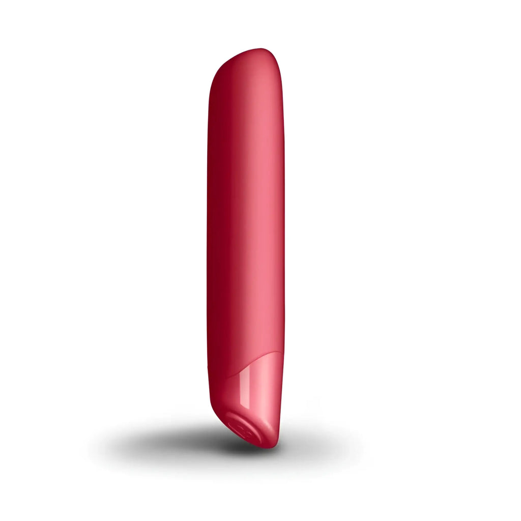 A sleek glossy red cylindrical rocks off sugarboo cool coral bullet vibe with a smooth rounded top and tapered bottom