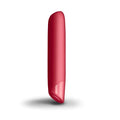 A sleek glossy red cylindrical rocks off sugarboo cool coral bullet vibe with a smooth rounded top and tapered bottom