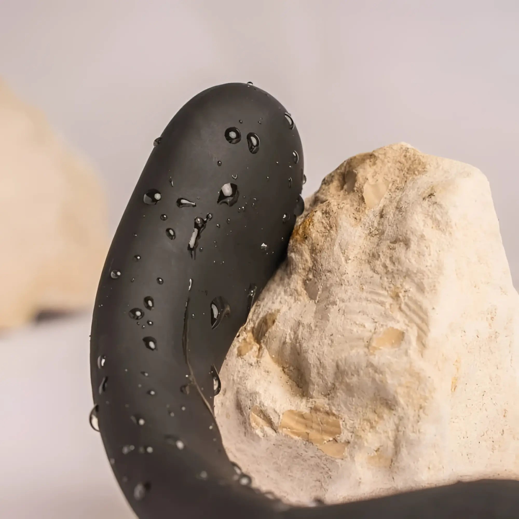 Black sleek curved silicone rocks off the vibe 10 speed remote cock ball and anal vibrator with water droplets