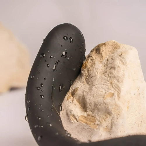 Black sleek curved silicone rocks off the vibe 10 speed remote cock ball and anal vibrator with water droplets