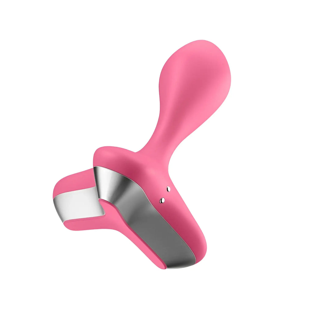 Pink silicone and stainless steel hair clip with sleek ergonomic design shown with satisfyer game changer vibrating anal plug pink