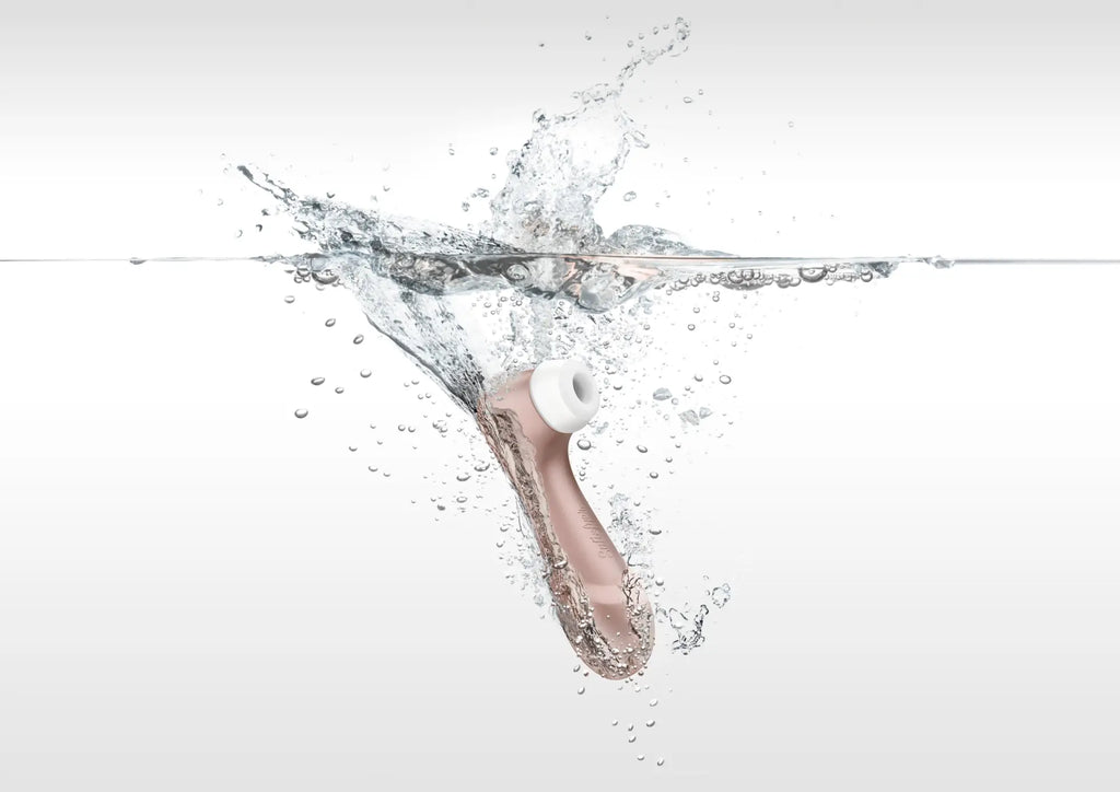 Rose gold satisfyer pro 2 g2 air pulse clitoral stimulator with white silicone head partially submerged in water