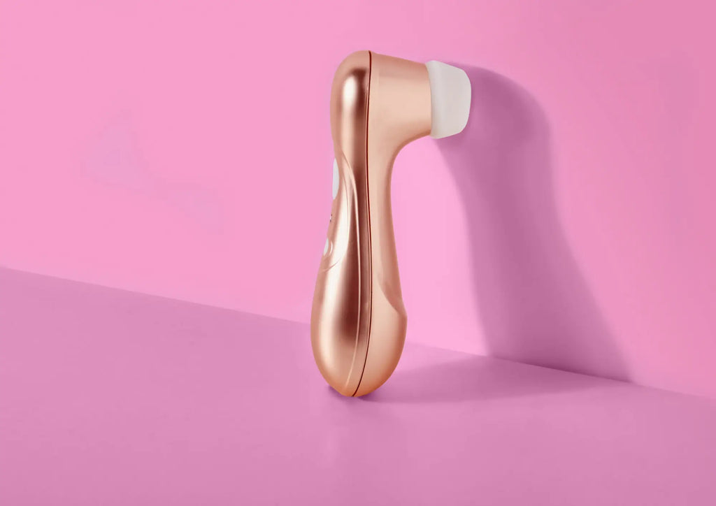 Satisfyer pro 2 g2 air pulse clitoral stimulator with rose gold metallic body and white silicone head in ergonomic design