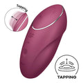 A sleek matte burgundy satisfyer tap and climax 1 red adult toy with silver accent ring and textured control buttons