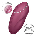 A sleek matte burgundy satisfyer tap and climax 1 red adult toy with silver accent ring and textured control buttons