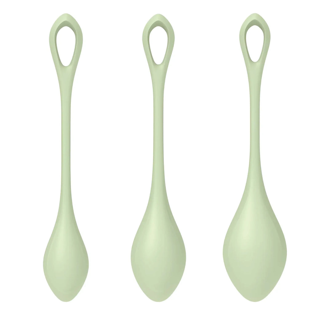 Three pale green silicone spoons with sleek rounded handles and oval bowls in the satisfyer yoni power balls 2 set