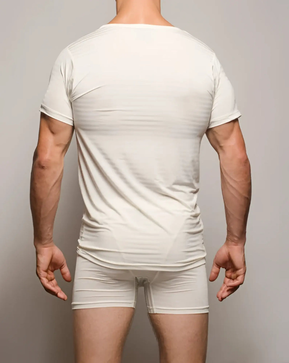 A sleek form-fitting white seamless active nylon t-shirt with short sleeves and a rounded neckline