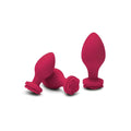 Set of three vibrant fuchsia silicone butt plugs including one rose design from Secret Kisses Rosegasm training set