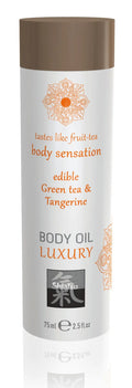 A sleek white cylindrical bottle with brown cap and orange floral design of shaiyu shiatsu luxury edible body oil