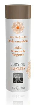 A sleek white cylindrical bottle with brown cap and orange floral design of shaiyu shiatsu luxury edible body oil