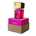 Vibrant fuchsia glass shiatsu pheromone fragrance bottle with gold and black square cap in branded packaging