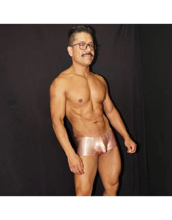 Shiny copper men's boxer underwear by Arroyman featuring a snug fit and smooth material modeled by a man.