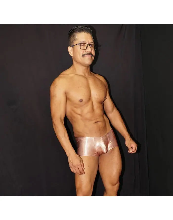 Shiny copper men's boxer underwear by Arroyman featuring a snug fit and smooth material modeled by a man.