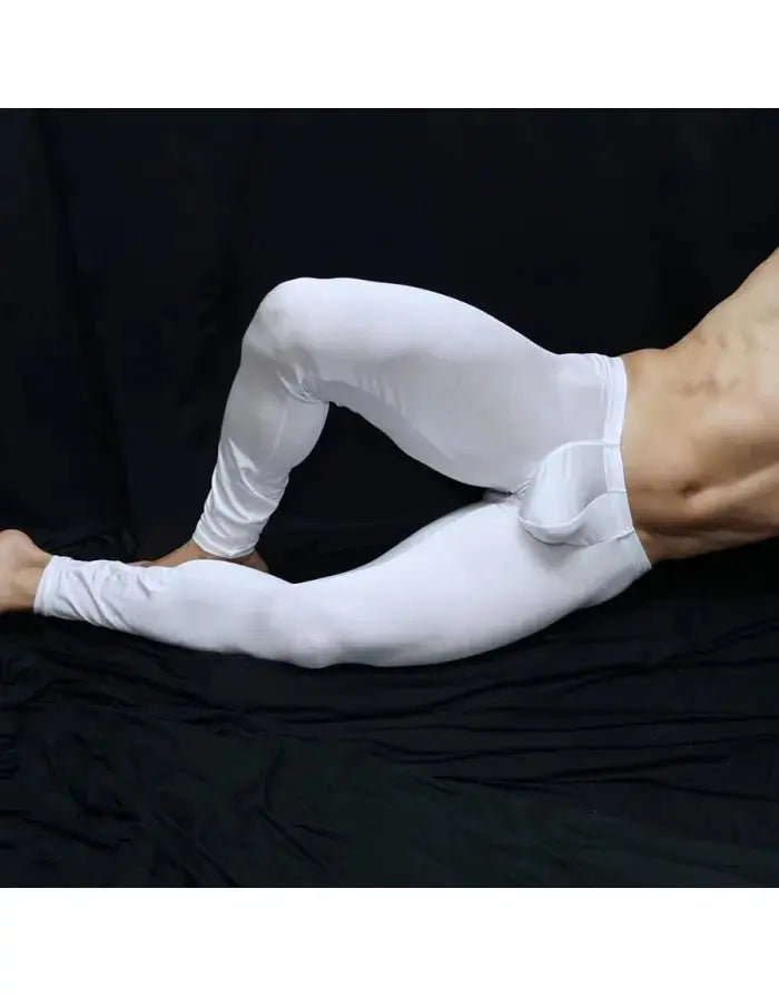 Shiny white gym tights by Arroyman featuring a snug fit and soft material shown on a model in a relaxed pose.