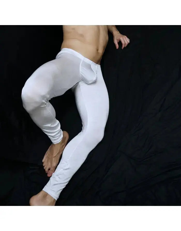 White shiny gym tights by Arroyman featuring a snug fit and a bulge design shown on a model against a black background.