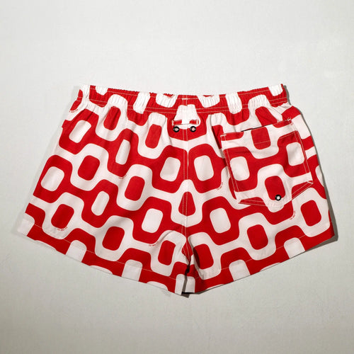 Red and white geometric shorts displayed flat.