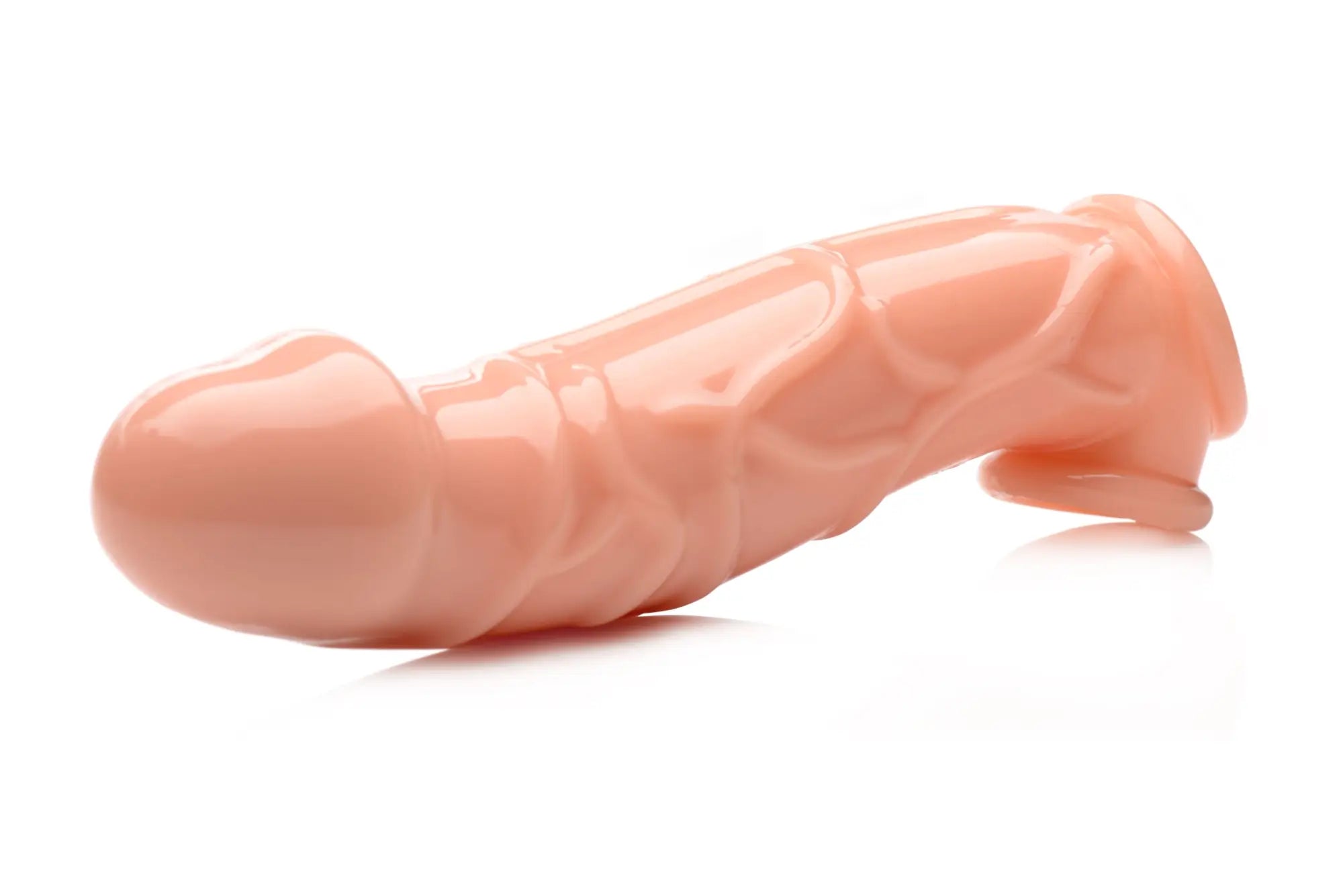 Peach-colored silicone condom size matters 2in extender sleeve with textured surface and tapered end for enhanced fit