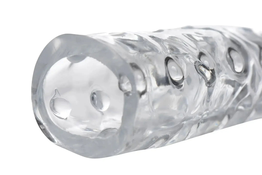 Size Matters 3in clear penis enhancer sleeve made of textured silicone with embossed circular patterns and glossy finish