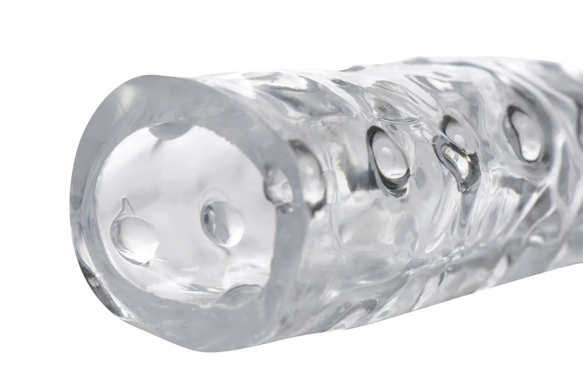 Size Matters 3in clear penis enhancer sleeve made of textured silicone with embossed circular patterns and glossy finish