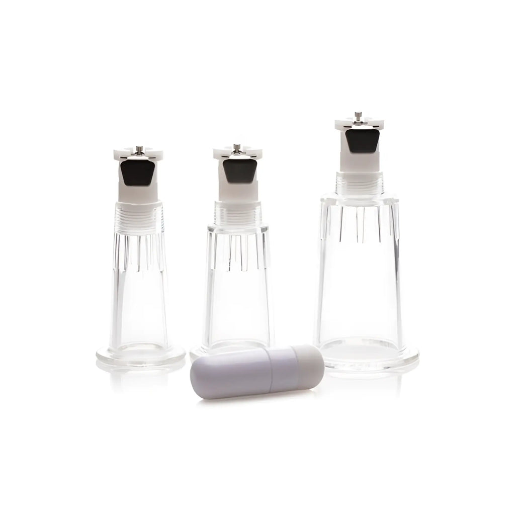 Clear plastic suction cups with white caps and black rubber seals with lavender cylindrical cap for size matters clitoral pump system