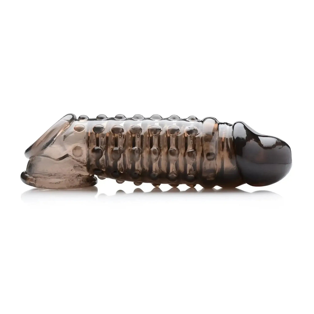 Transparent amber silicone cock ring with textured ridges and rounded ends from size matters penis enhancer sleeve.