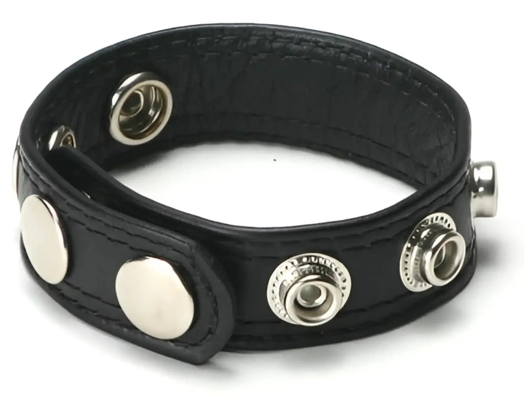 Black leather bracelet with silver-toned snap buttons and textured surface included in size matters premium pumping kit.