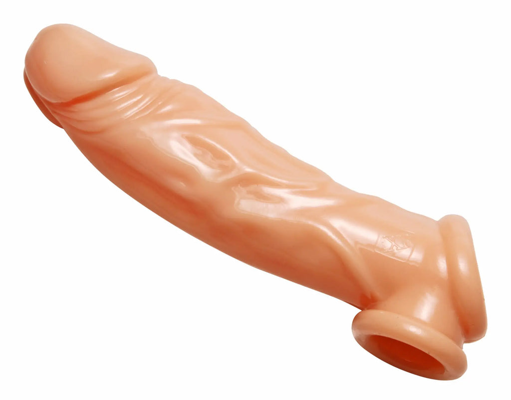 Peach-colored silicone condom cover with realistic texture and tapered ends for Size Matters flesh enhancer and ball stretcher