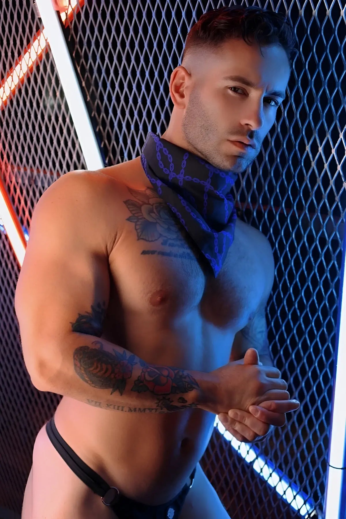 Blue patterned bandana worn around the neck in the slay-kerchief bound style accessory