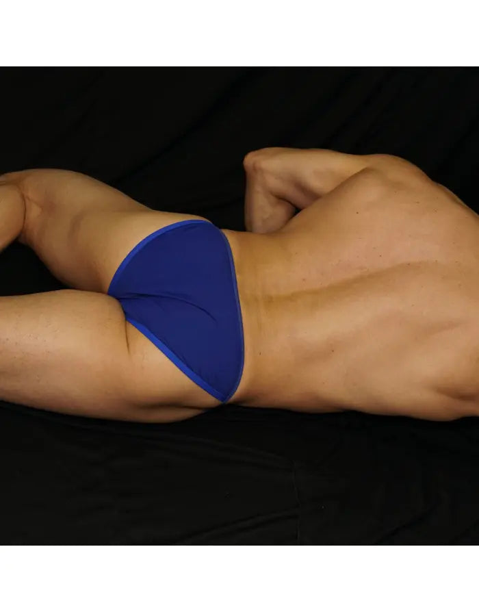 Blue bikini underwear by Arroyman featuring a low-rise cut and smooth fabric shown on a model from the side.
