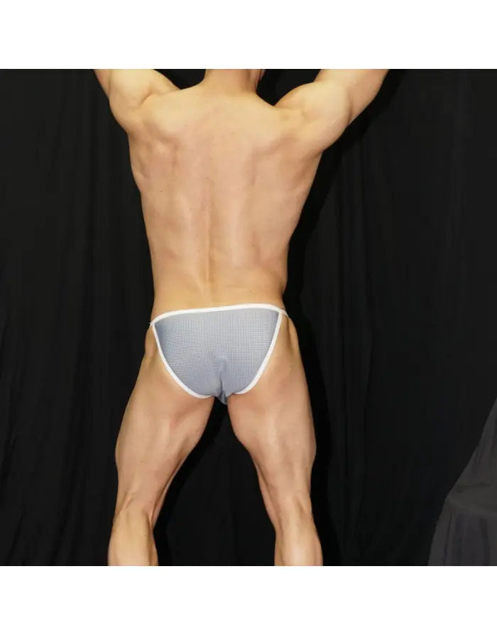 Men's bikini underwear in a checkered pattern featuring a white waistband shown on a model from the back by Arroyman.