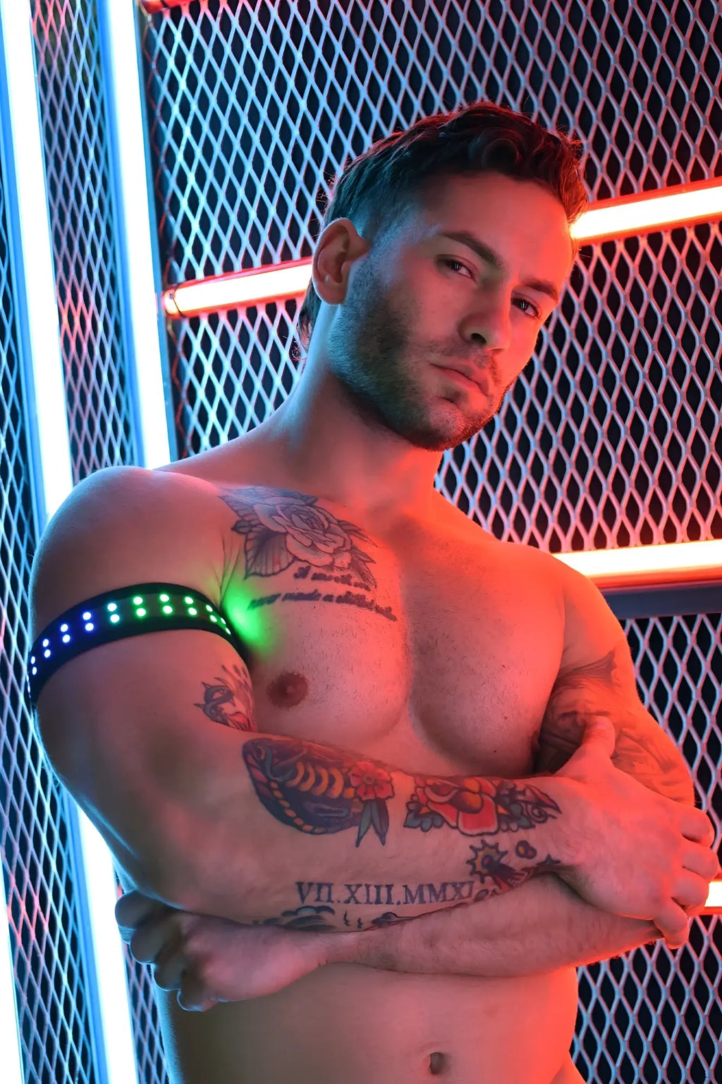 A sleek black soundwave armband with glowing green LED lights encircling the upper arm for active use