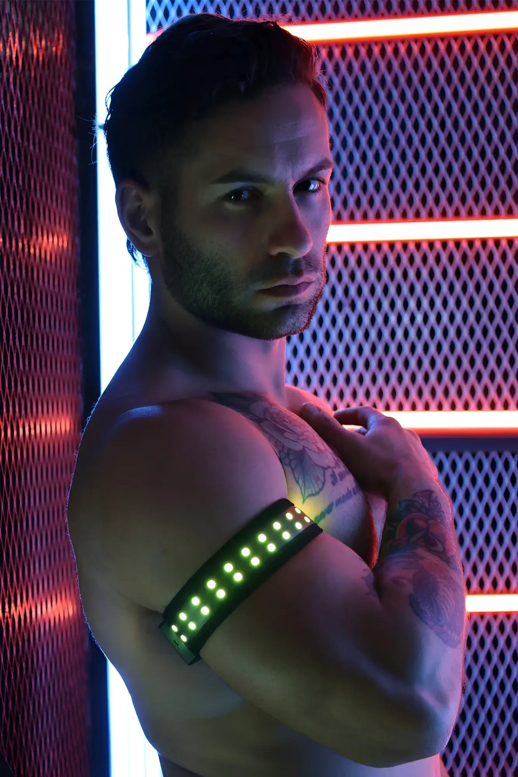 A sleek black led soundwave armband with glowing green lights designed for wearable audio control