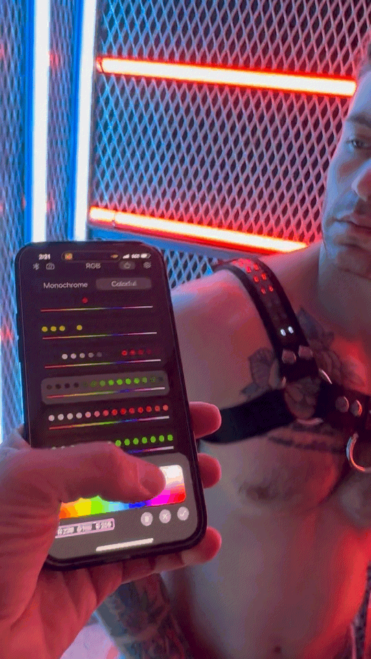 Black smartphone displaying color adjustment app with vibrant red and blue neon lights background for soundwave bulldog