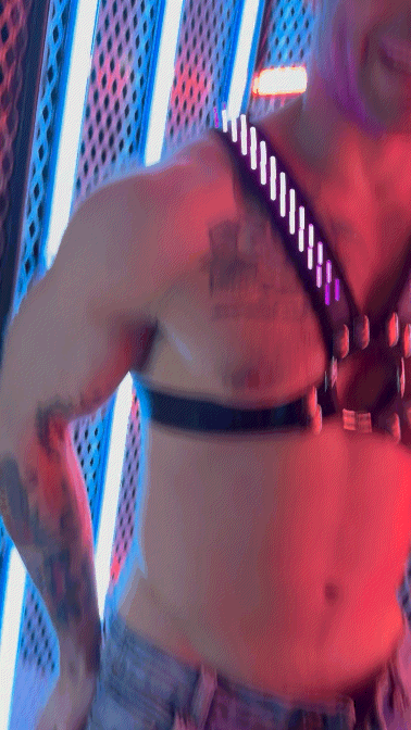 Black leather soundwave cross harness with silver studs and glowing led lights front view