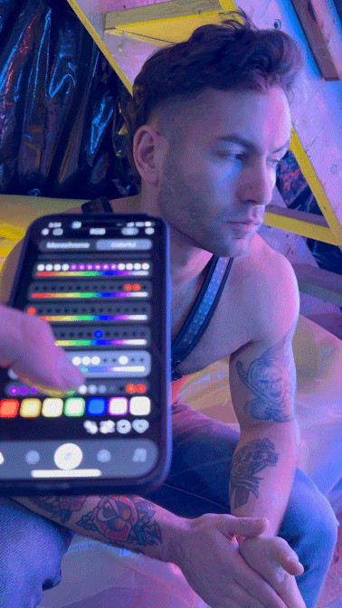 A sleek black smartphone displaying a vibrant color picker interface for the soundwave cross harness product design