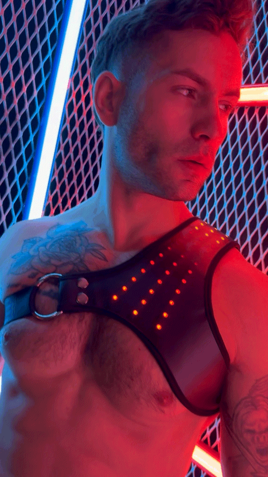 Black leather soundwave synergy harness with orange led lights in a grid pattern embedded on the front side